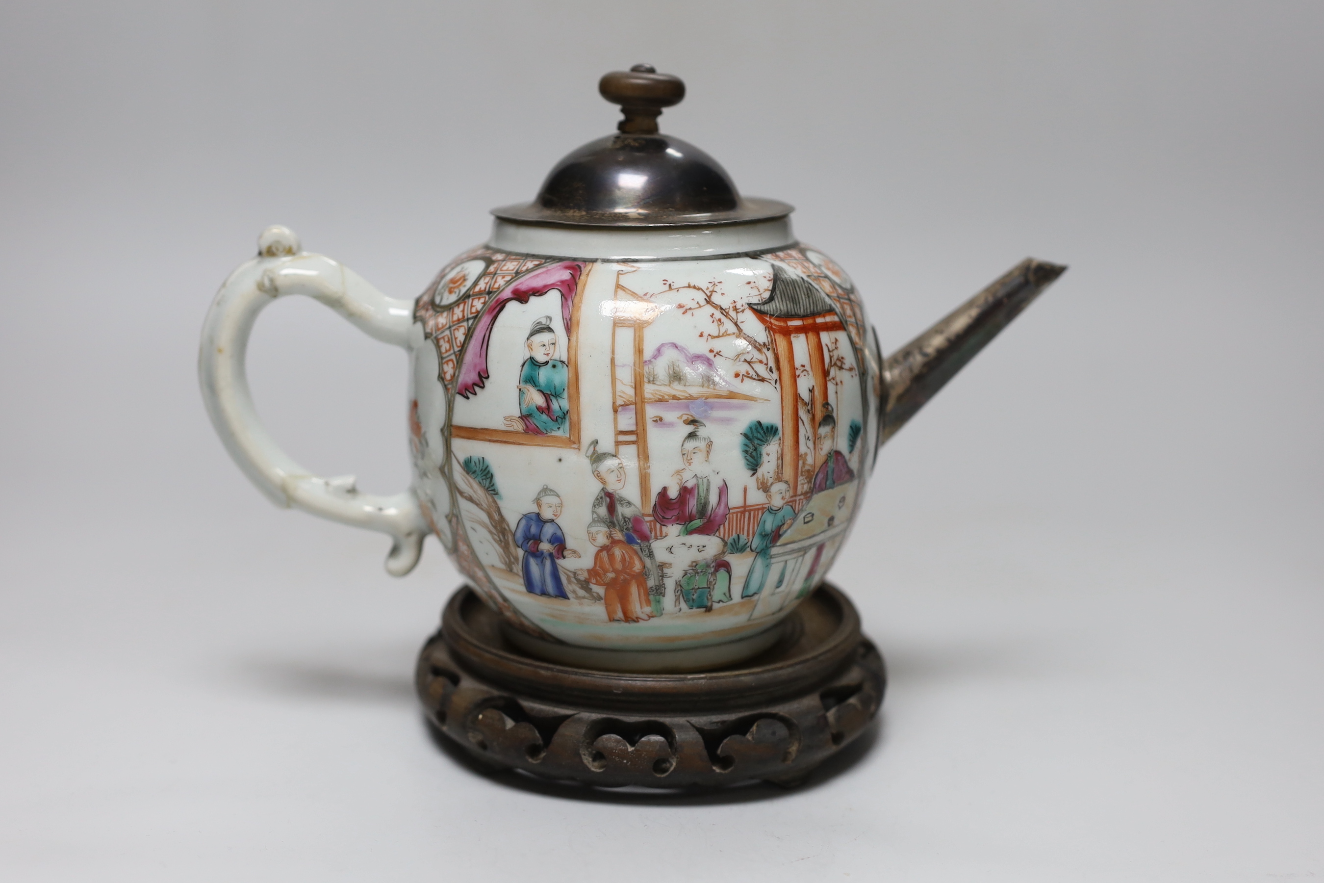 An 18th century Chinese export famille rose teapot with later silver spout and cover, on hardwood stand